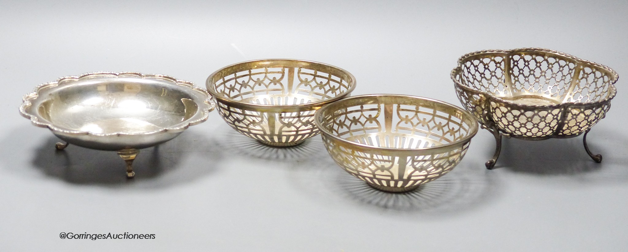 A pair of Edwardian pierced silver circular small bowls, Walker & Hall, Sheffield, 1909, 10.6cm and two other silver bowls, 10oz.